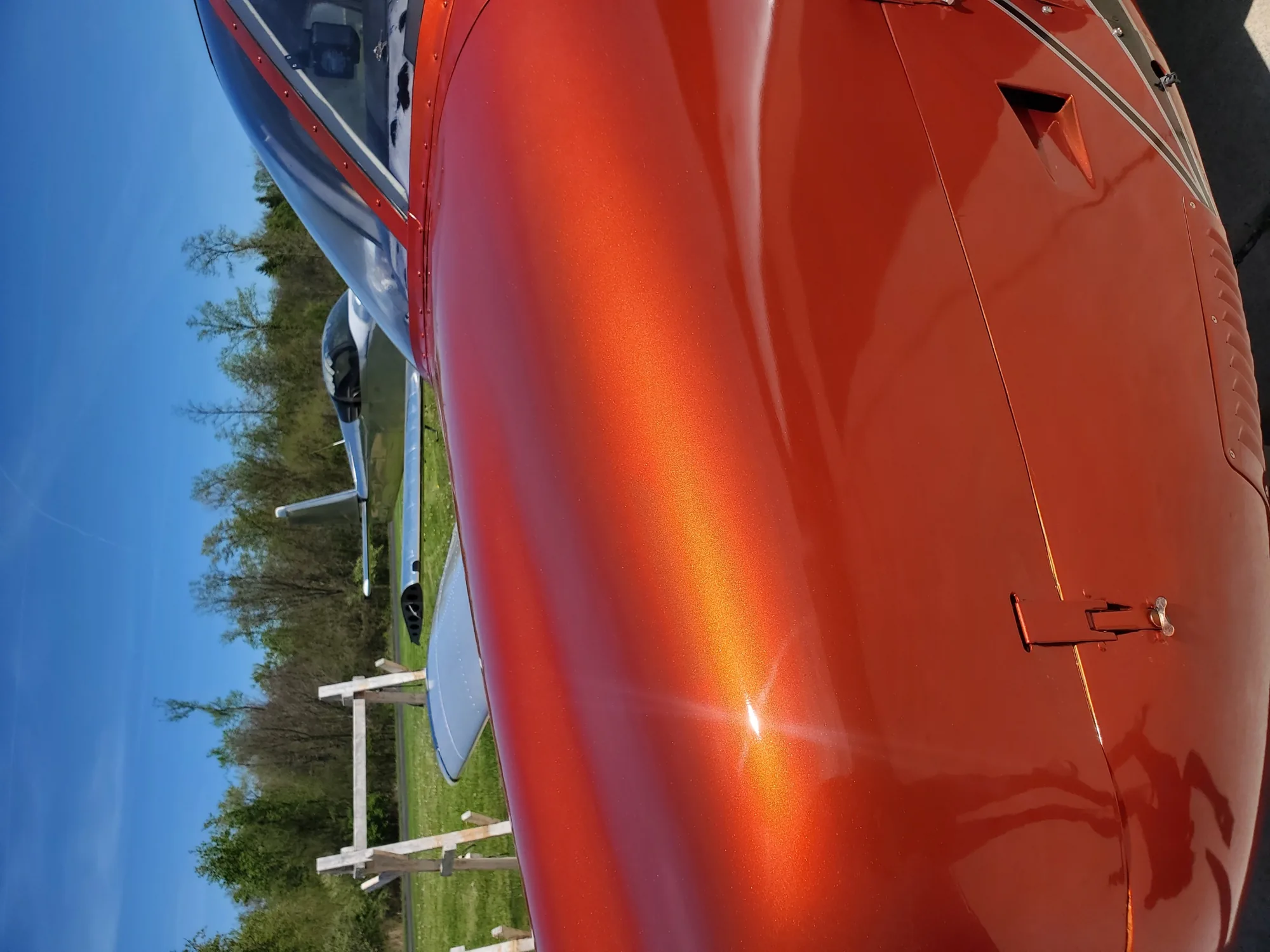 Metallic orange aircraft paint in sunlight